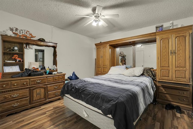 bedroom featuring ceiling fan, dark hardwood / wood-style flooring, and a textured ceiling