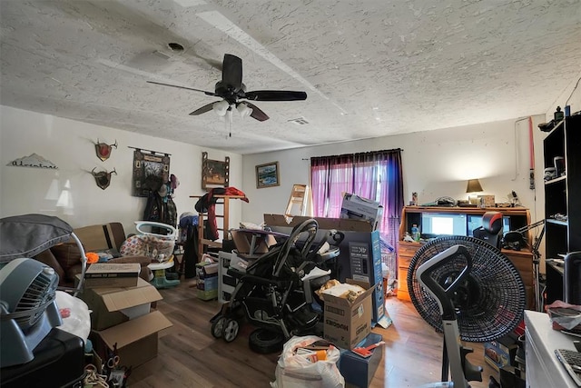 interior space featuring hardwood / wood-style flooring, ceiling fan, and a textured ceiling