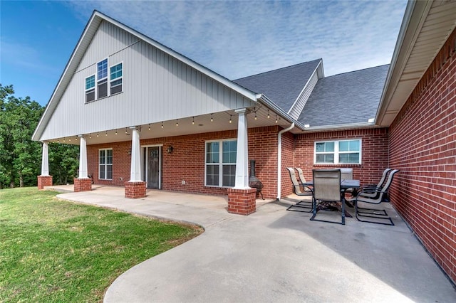 back of property featuring a patio and a lawn