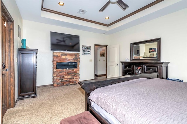 carpeted bedroom featuring a raised ceiling, ceiling fan, and crown molding