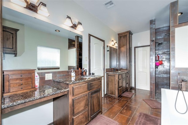 bathroom featuring tile patterned flooring, vanity, and separate shower and tub