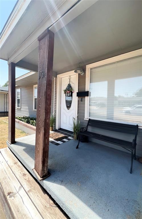 view of exterior entry with a porch