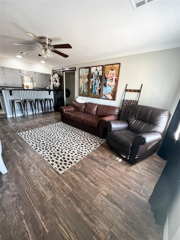 living room featuring hardwood / wood-style flooring, a barn door, and ornamental molding