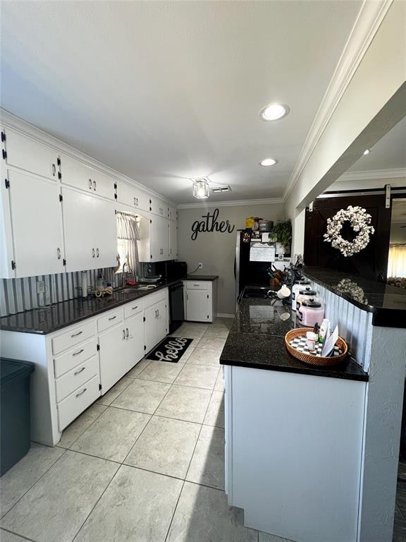 kitchen with black dishwasher, white cabinetry, crown molding, and sink