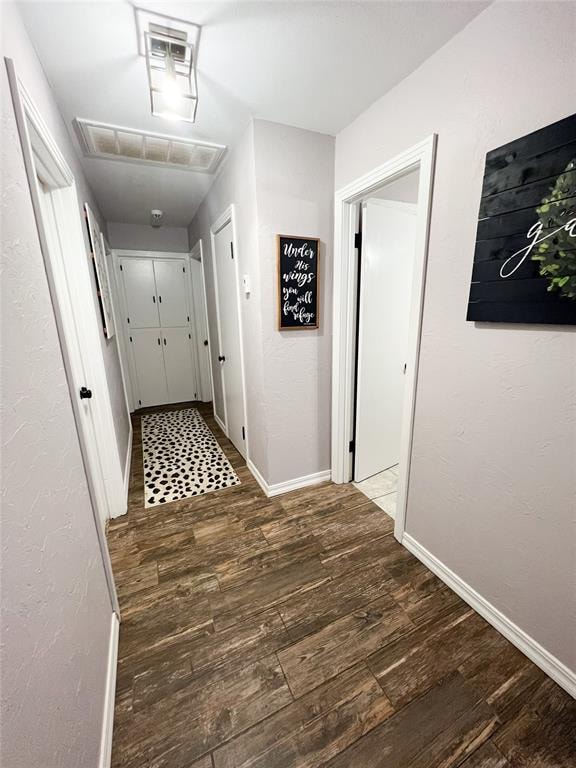 hallway with dark hardwood / wood-style flooring