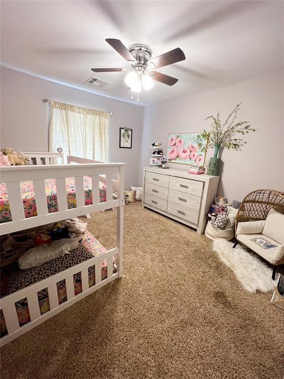 bedroom featuring ceiling fan and carpet