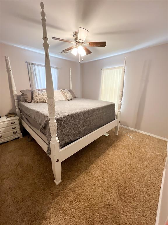 bedroom with ceiling fan and dark carpet