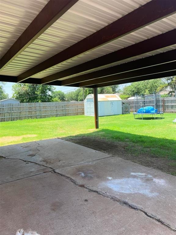 view of patio with a storage unit and a trampoline