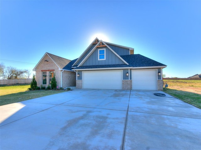 craftsman inspired home with a garage and a front lawn