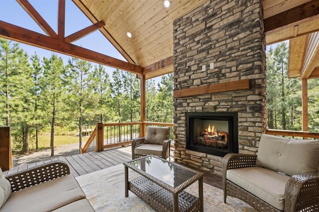 view of patio with an outdoor living space with a fireplace and a deck