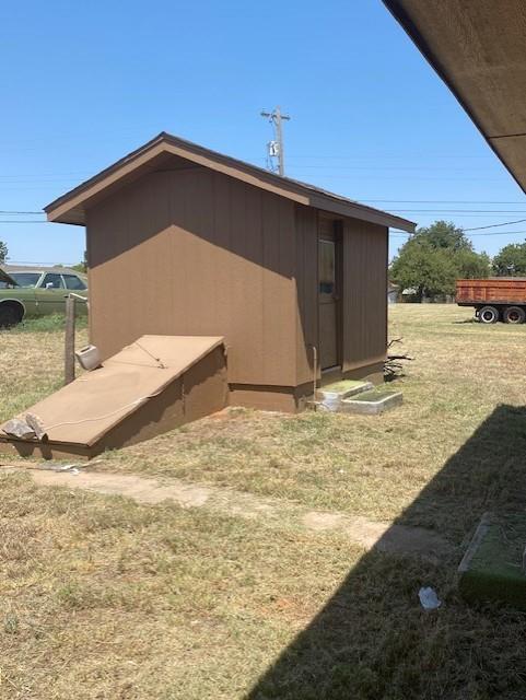 view of side of home with a lawn