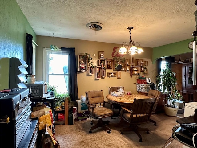 dining room with carpet floors, a textured ceiling, and an inviting chandelier