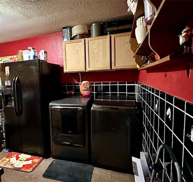 kitchen with black fridge with ice dispenser, a textured ceiling, light brown cabinetry, washer and dryer, and tile walls