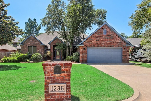 view of property with a garage and a front yard