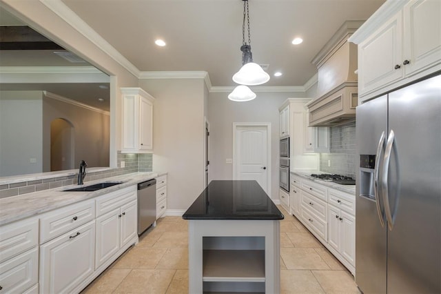 kitchen featuring tasteful backsplash, stainless steel appliances, sink, light tile patterned floors, and white cabinets