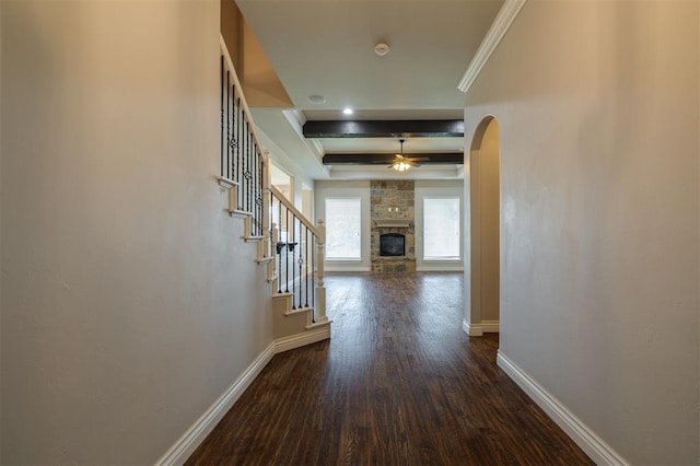 corridor with beam ceiling, dark hardwood / wood-style flooring, and crown molding