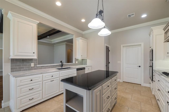 kitchen featuring appliances with stainless steel finishes, backsplash, white cabinetry, and sink