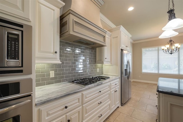 kitchen with appliances with stainless steel finishes, pendant lighting, light tile patterned flooring, custom range hood, and ornamental molding