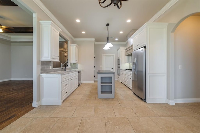 kitchen featuring white cabinets, decorative light fixtures, stainless steel appliances, and ceiling fan