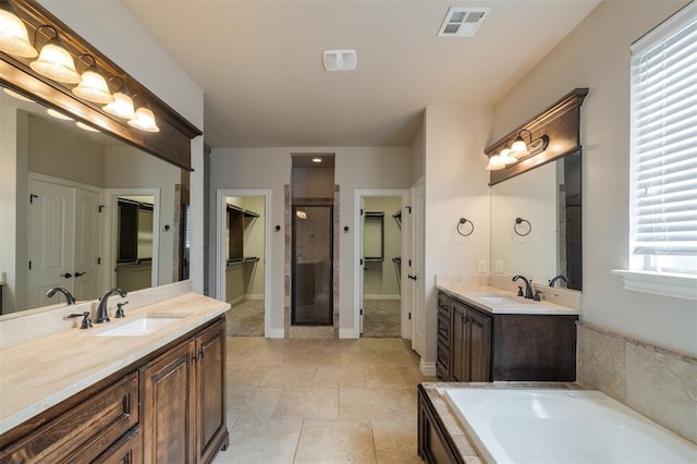 bathroom featuring tile patterned floors, vanity, and separate shower and tub