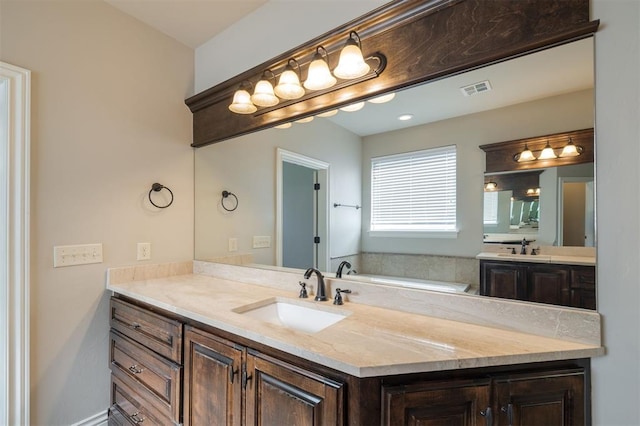 bathroom with a bath and vanity