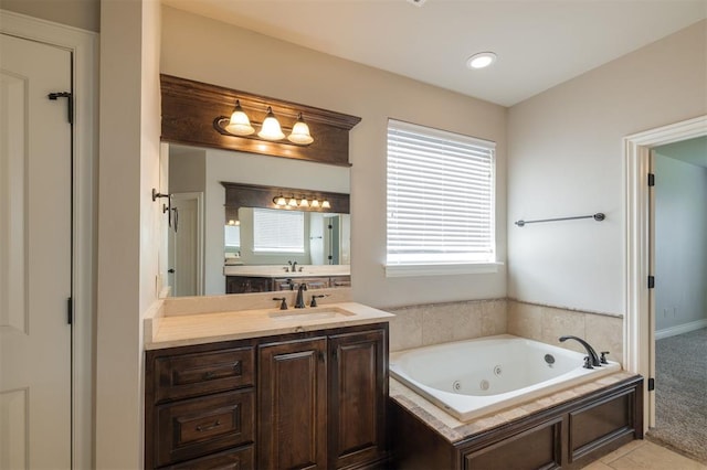 bathroom featuring a tub to relax in, tile patterned flooring, and vanity