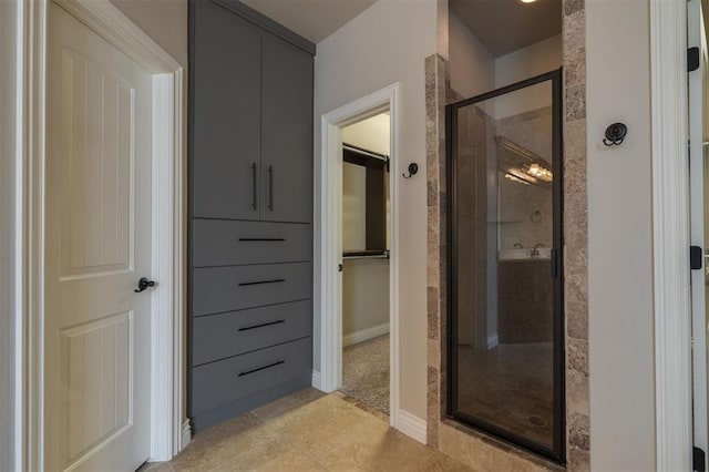 bathroom with a shower with door