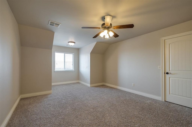 additional living space with carpet flooring and ceiling fan