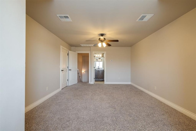 empty room with ceiling fan and carpet floors