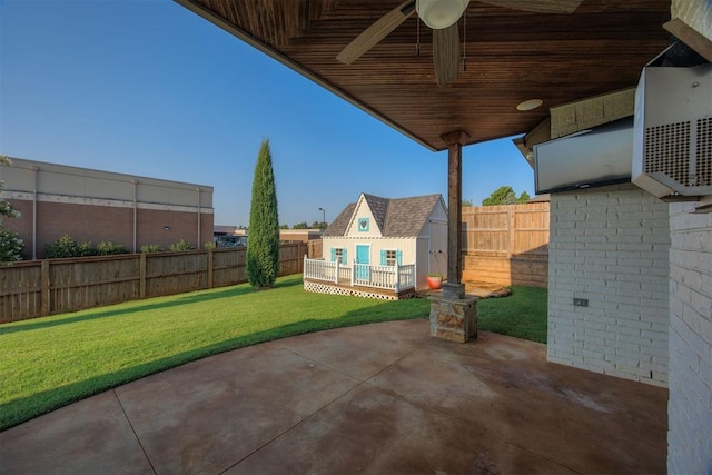 view of patio / terrace featuring ceiling fan and an outbuilding