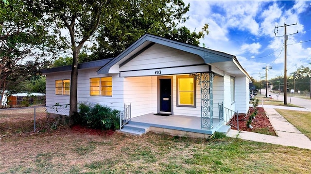 bungalow with a front lawn and a porch