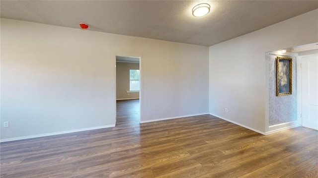 empty room with dark wood-type flooring