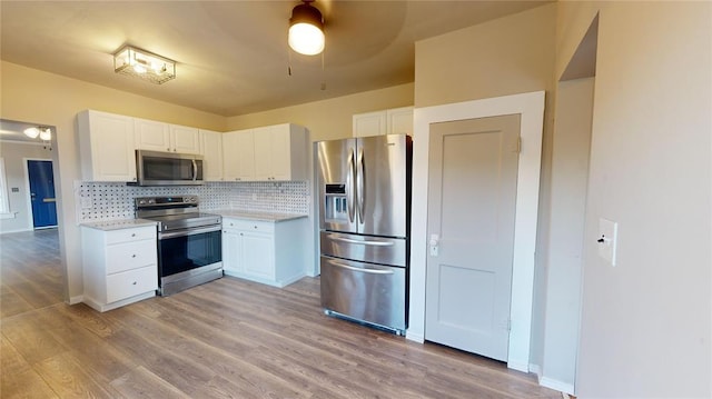 kitchen featuring white cabinets, stainless steel appliances, and light hardwood / wood-style floors