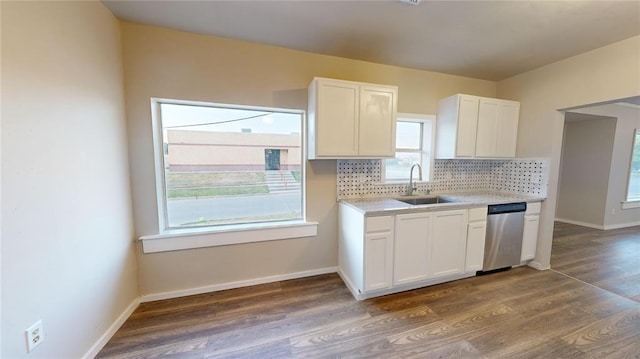 kitchen with decorative backsplash, white cabinetry, dark wood-type flooring, and sink