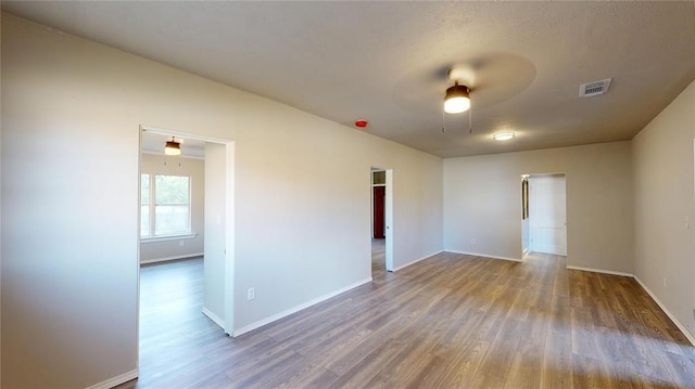 unfurnished room featuring wood-type flooring and ceiling fan