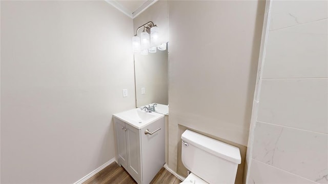 bathroom with vanity, wood-type flooring, and toilet