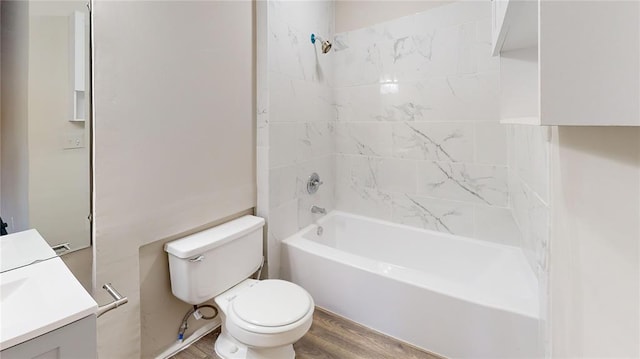 full bathroom featuring toilet, hardwood / wood-style floors, vanity, and tiled shower / bath combo