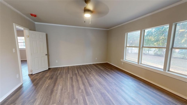 unfurnished room featuring ceiling fan, dark hardwood / wood-style floors, and ornamental molding