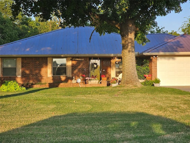 ranch-style house featuring a front yard and a garage