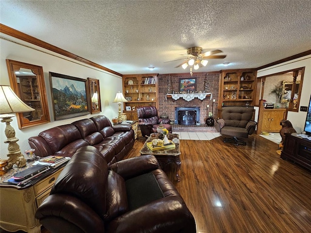 living room with a fireplace, a textured ceiling, hardwood / wood-style flooring, and ornamental molding