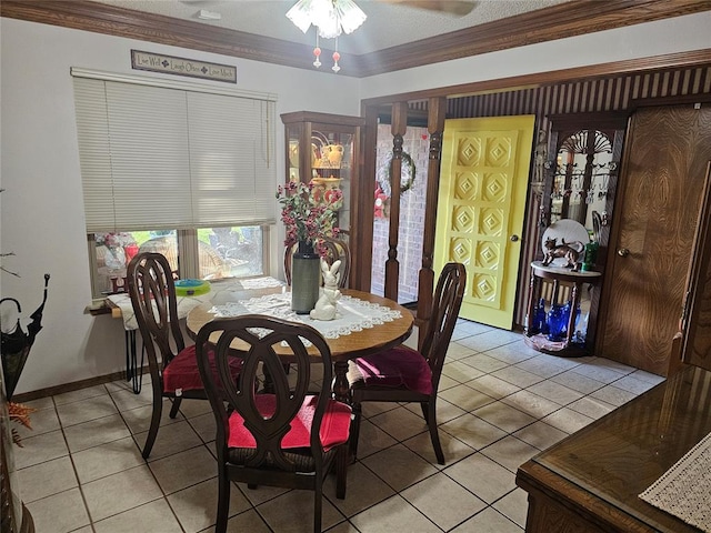 dining room with light tile patterned floors, ceiling fan, and crown molding