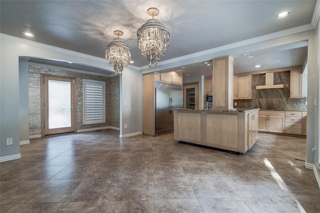 kitchen featuring light brown cabinetry, premium range hood, crown molding, a notable chandelier, and built in fridge