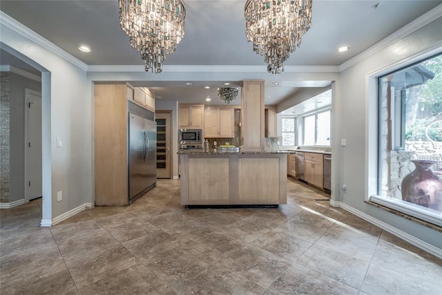 kitchen featuring light brown cabinets, a center island, a notable chandelier, built in appliances, and crown molding