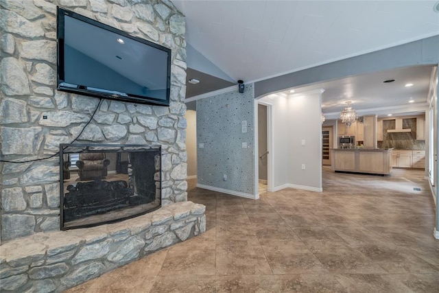 living room with a stone fireplace, lofted ceiling, and ornamental molding