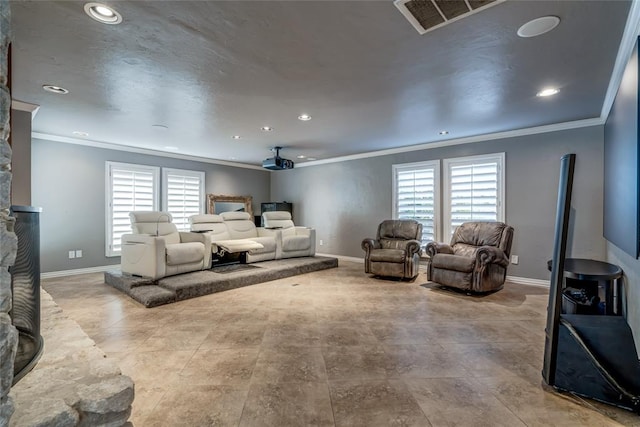 home theater room with ornamental molding and a wealth of natural light