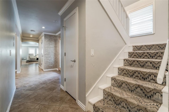 stairs featuring tile patterned flooring and ornamental molding