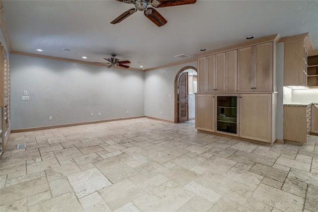 unfurnished living room with ceiling fan and ornamental molding