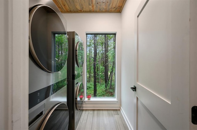 laundry area with stacked washer / dryer, wooden ceiling, and wood-type flooring