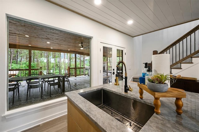 kitchen featuring dark hardwood / wood-style flooring, wooden ceiling, and a wealth of natural light