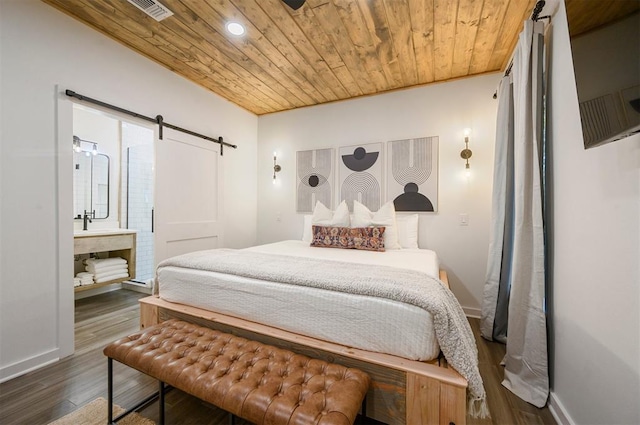 bedroom with a barn door, ensuite bathroom, wood ceiling, and dark hardwood / wood-style floors